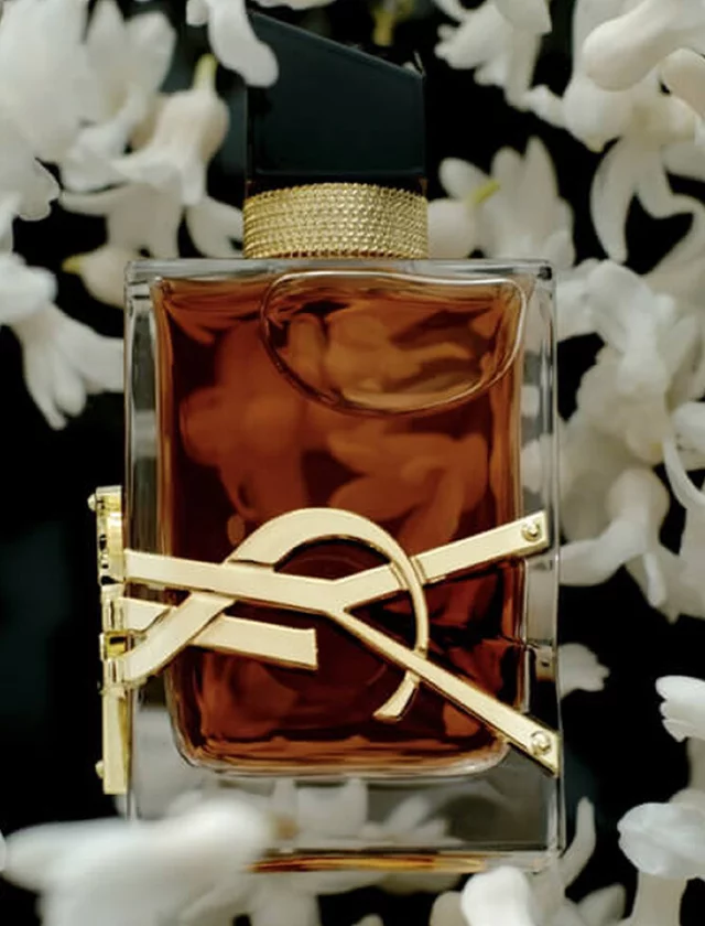Official YSL product photograph of Libre Eau de Parfum Intense among white flowers