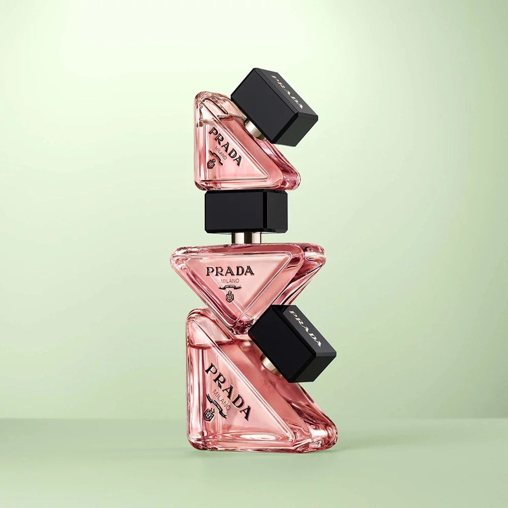 Official Prada photograph showing three complete Paradoxe Eau de Parfum bottles against a pale green background